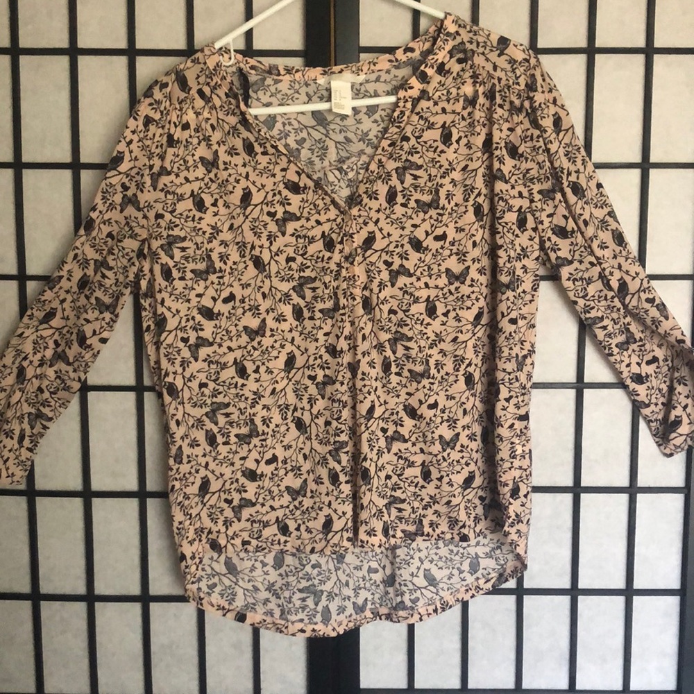 A baby pink blouse with a nature design